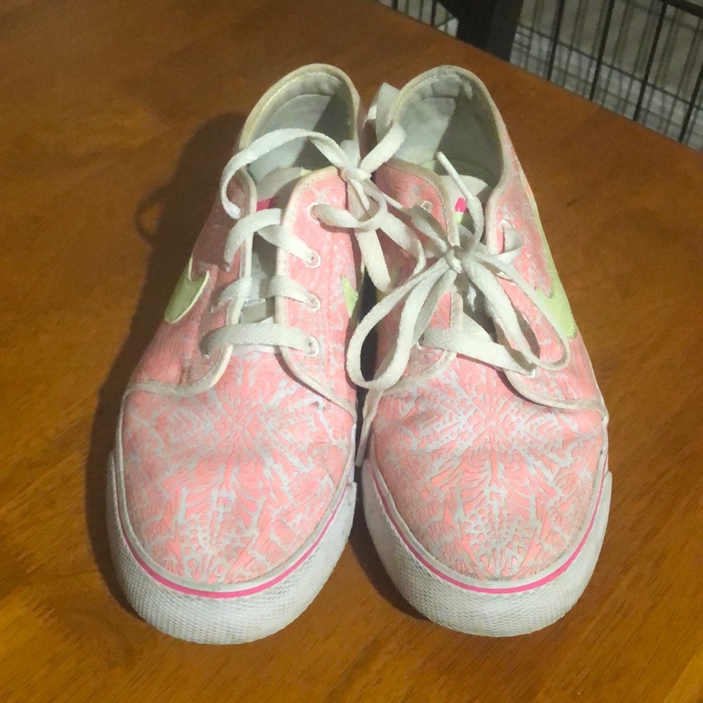 White pink and neon green Nike shoes